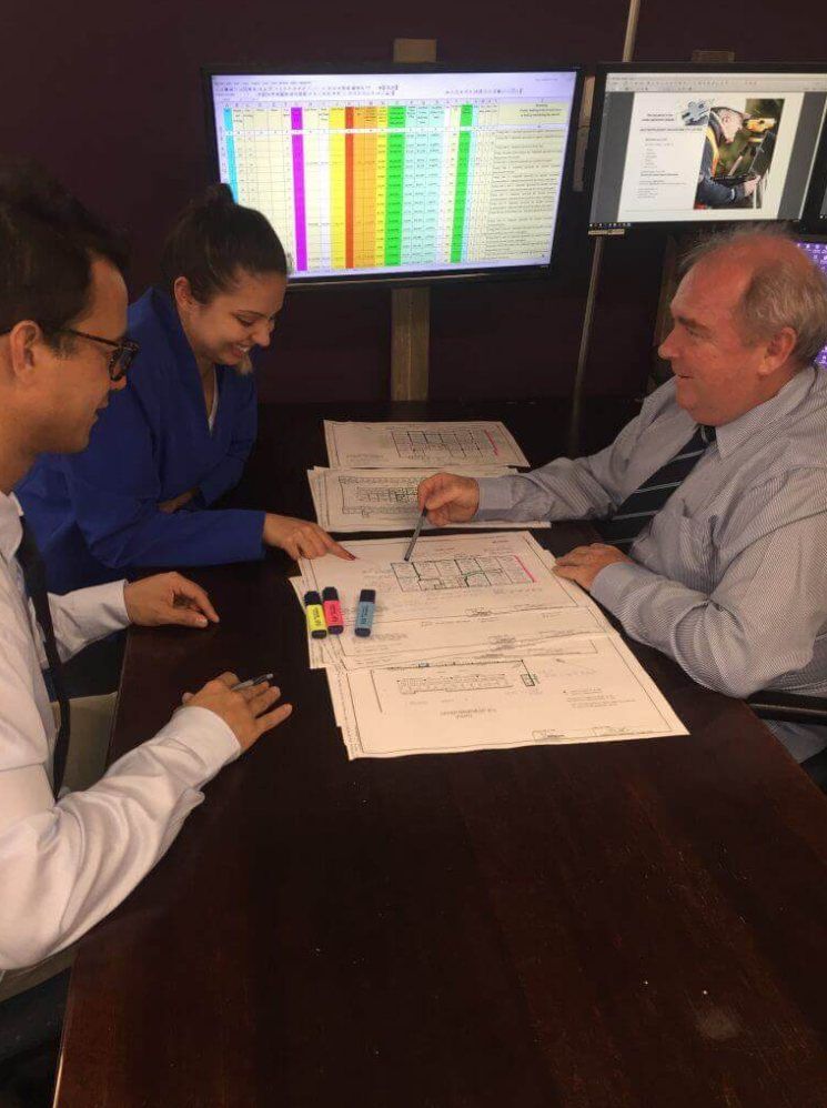Qualified Valuers reviewing strata plan drawings and unit entitlement calculations